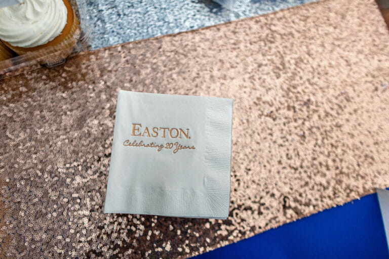 A napkin on a table with the Easton Celebrating 20 Years logo on it.