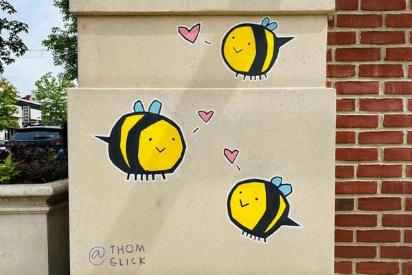 Three bees painted onto the side of a building at Easton.
