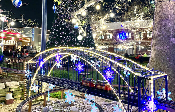 The Easton Express Railway lit up with holiday lights and décor at night.