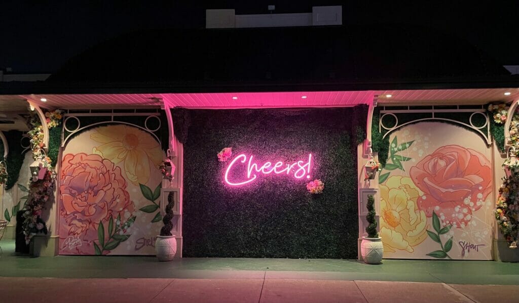 Prosecco Plaza at night with the pink Cheers sign illuminated.