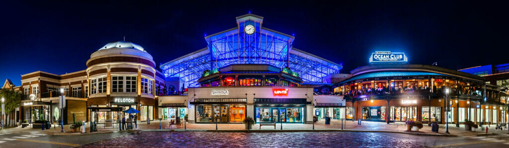 Exterior of the Station Building at night and surrounding brands at Easton Town Center.
