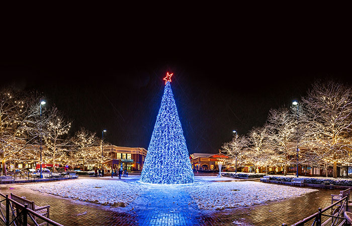 A holiday tree lit up at night on the Town Square at Easton.