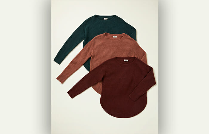 Three different colored UpWest sweaters.