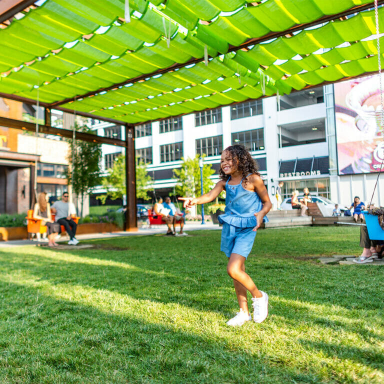 A young girl dancing on The Yard at Easton.