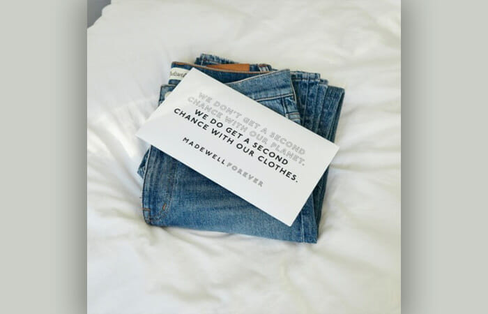 Madewell jeans on a white sheet.