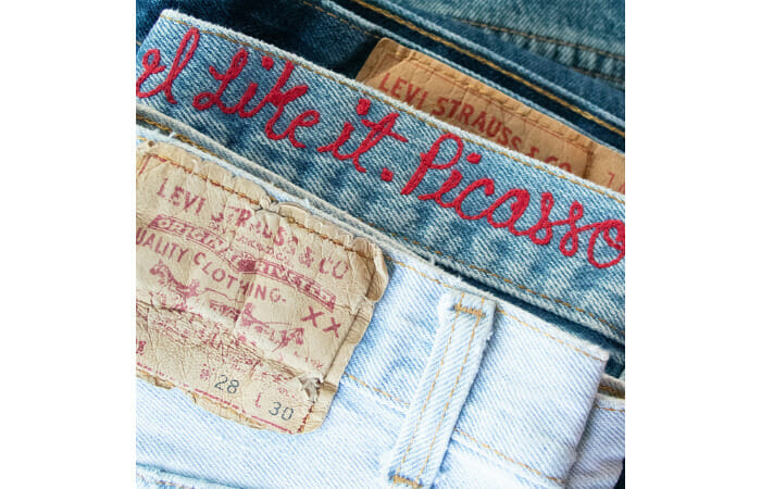 Waist band of Levi's jeans with I like it. Picasso. monogrammed in red.
