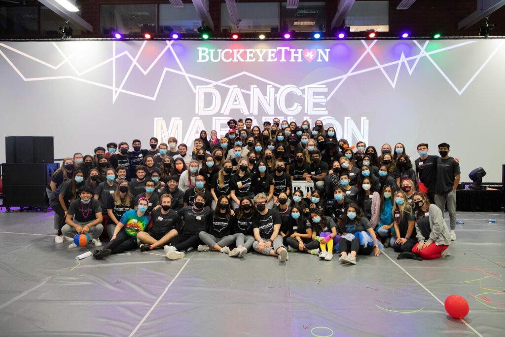 Ohio State students pose for a group shot in front of Dance Marathon projection.