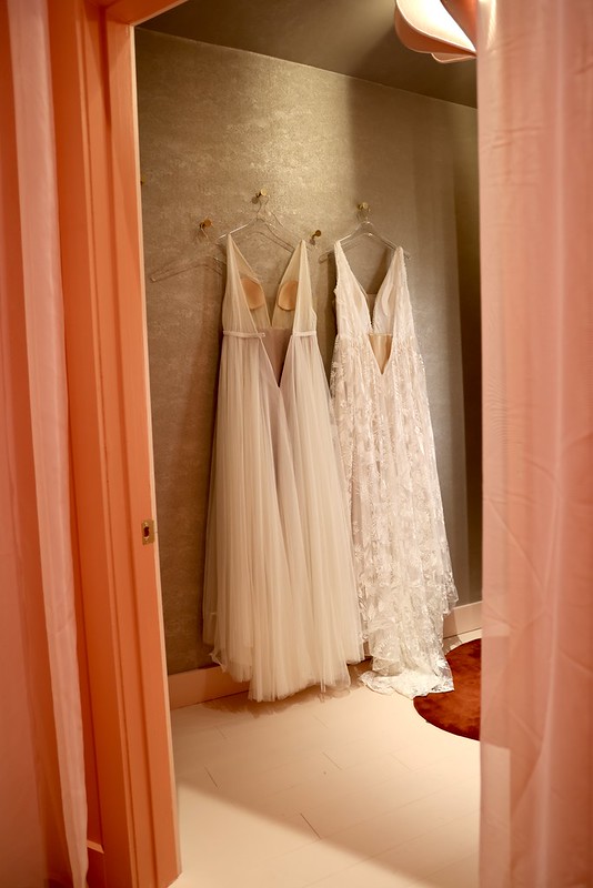 Wedding dresses hanging in fitting room