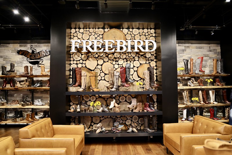 Back wall in Freebird with boots across multiple shelves