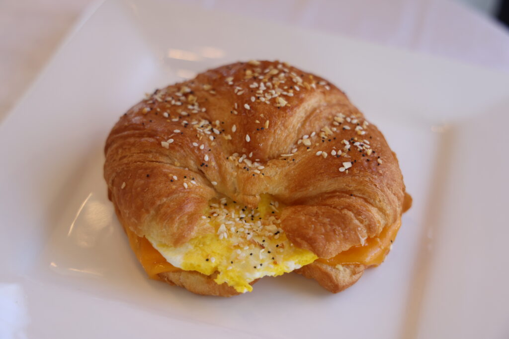 Egg and cheese breakfast croissant topped with everything bagel seasoning