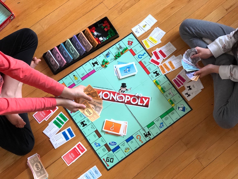 Two people playing Monopoly.