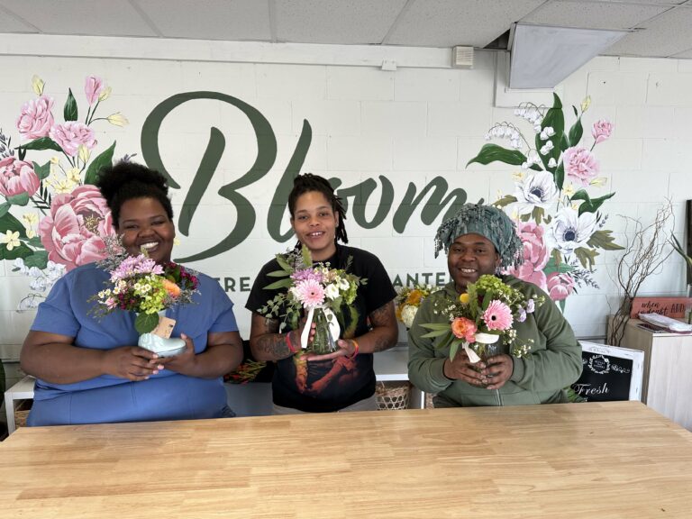 Three women holding bouquets at Star House in Columbus, OH.