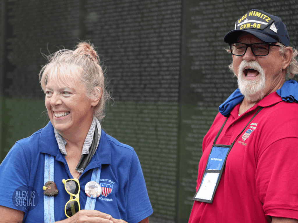 Two people smiling and laughing during an Honor Flight trip.