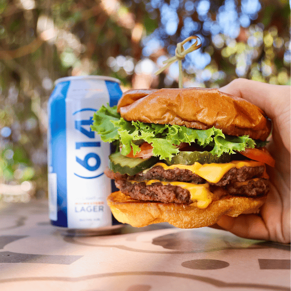 A burger and a can of 614 Lager from Fado Irish Pub.