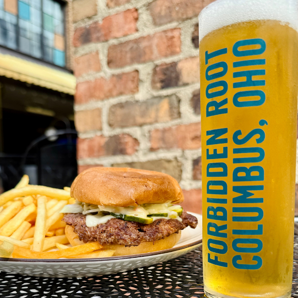 A burger and a glass of beer from Forbidden Root