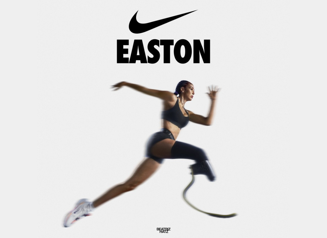 Nike swoosh logo with the name Easton underneath, women running wearing a black athletic set and running shoes with a prosthetic leg.