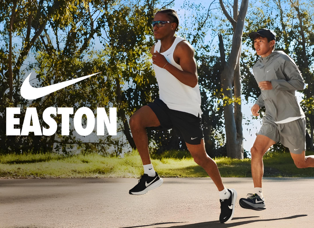Nike swoosh logo with the title Easton underneath. Two men wearing Nike athletic apparel running outside during a sunny day.
