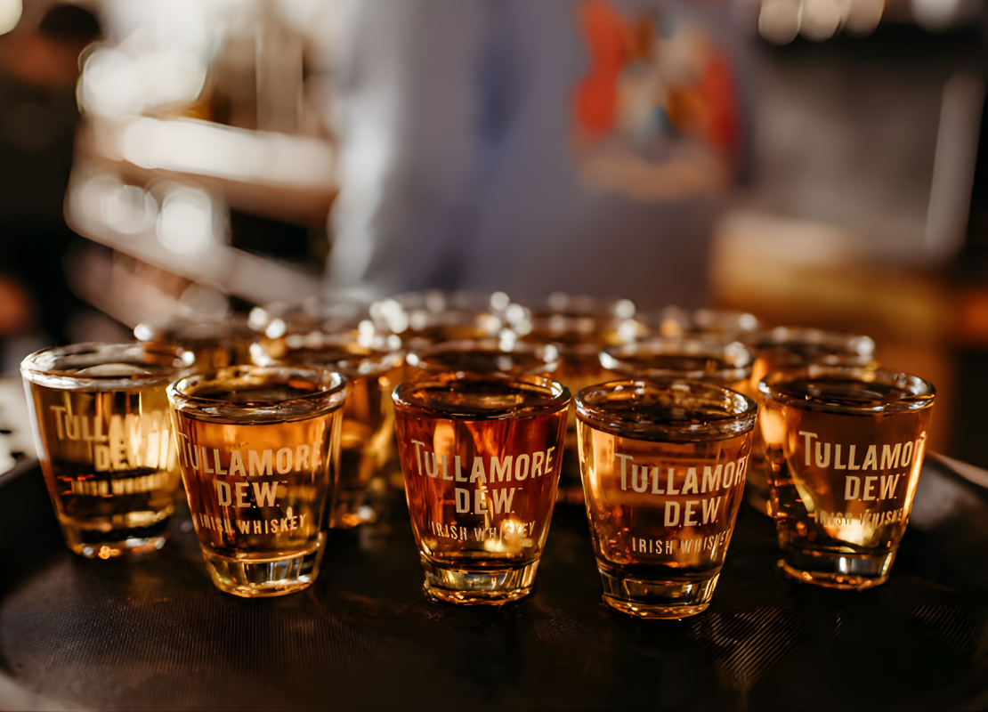 A tray of tasting glasses filled with Tullamore D.E.W. irish whiskey.