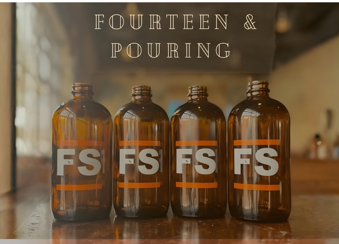 Image of four brown glass bottles labeled FS sitting on a table inside a restaurant with the text fourteen and poruing