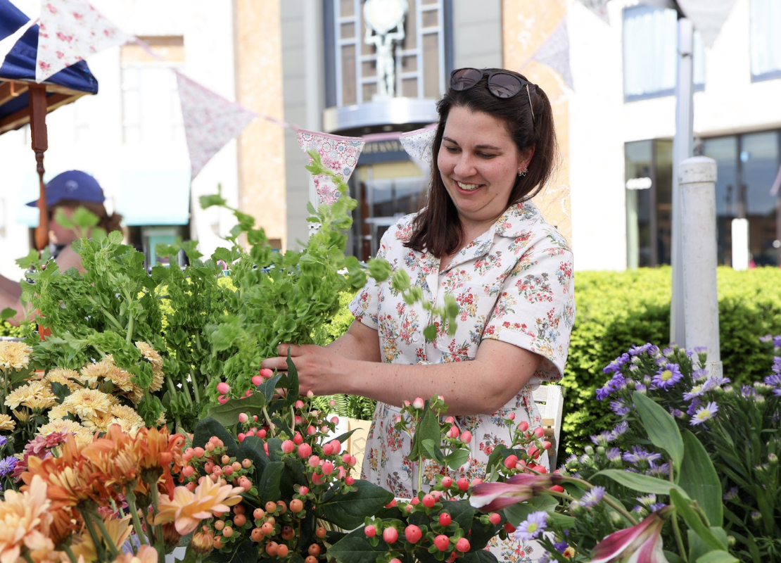 Woman outside shopping floral bouquets