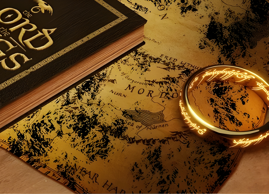 Lord of the rings book and a ring sitting on top of a map